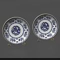 Blue and White Ceramic Plates Featuring Dragon Motifs and Patterns on Display Stands