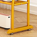 Yellow Metal Clothing Rack with Hanging Folded Clothes and Shoes in Indoor Setting with Window
