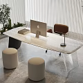 Modern Desk with Apple Computer Books Brown Chair Beige Stools Green Plants in Bright Room