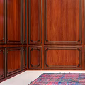 Elegant Green Velvet Single Sofa in Room with Wooden Paneled Walls and Colorful Rug
