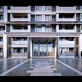 Contemporary Building Exterior Featuring Glass Facade Balconies And Stone Entrance Path