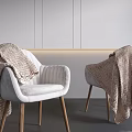 White Upholstered Leisure Chairs With Wooden Legs And Knitted Blankets In Minimalist Grey Room