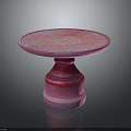 Pink Round Pedestal Table With Modern Smooth Surface And Decorative Base