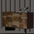 Modern Chest of Drawers Featuring Geometric Patchwork Panels Brass Handles and Decorative Items