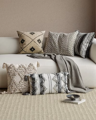 Stylish Decorative Pillows With Textured Patterns And Neutral Tones On Cozy Sofa 3d model