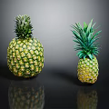 Fresh Ripe Pineapples of Different Sizes on Black Reflective Surface