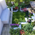 Rockery Stones Featured In Lush Garden Design With Green Lawn And Colorful Plants