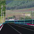 Outdoor Lights Along Highway With Street Lamps Green Mountains And Cars Driving