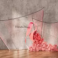 Floral Installation With Transparent Curved Structures And Pink Flowers On Wooden Floor