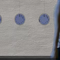 Walking woman passing by multiple clocks on wall with light and shadow effects
