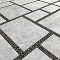 Garden Patio Design With Gray Stone Slabs And Black Pebbles In Between Spaces