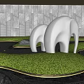 White Abstract Elephant Sculpture in Outdoor Garden With Green Grass And Gray Stone Wall