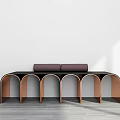 Modern Bench With Black Cushion And Copper Arched Frame Against White Wall Gray Floor