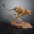 Spotted Cheetah Leaping On Brown Rock With Raised Tail And Flying Dust