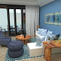 Modern Cozy Blue Themed Living Room With Warm Wooden Furniture And Large Glass Sliding Doors