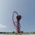 Red Spiral Structure Observation Deck on Top With Blue Sky and Green Landscape