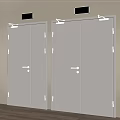 Silver Safety Exit Doors With Green Directional Signs In Building