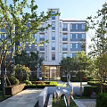 Modern Residential Building With Landscaped Gardens Trees And Contemporary Sculpture