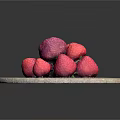 Fresh Ripe Strawberries With Green Leaves On Round Stone Cutting Board Against Black Background