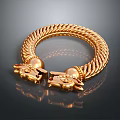 Gold Braided Bracelet With Intricate Dragon Head Decorations And Shiny Surface