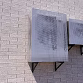 Two Air Conditioner Vents On Gray Brick Wall Mounted With Black Brackets And Grid Design