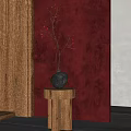 Black Vase With Small Orange Flowers On Wooden Cylindrical Pedestal Against Deep Red Wall