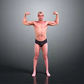 Shirtless Man Flexing Muscles In Black Underwear Against Gray Background
