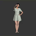 Woman Posing in Light Green Dress Taking Selfie with Mobile Phone Against Gray Background