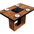 Modern Wooden Dining Table With Central Black Cooktop And Four White Plates