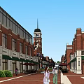 Charming Commercial Street With Red Brick Buildings Clock Tower Storefronts Awnings Greenery And Pedestrians
