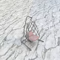 White Woven Swing Chair With Pink Cushion In Green Grass Field