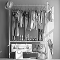 Different Colored Clothes Hanging On Rack With Coats Shirts Boots Suitcase Bags And Umbrella