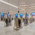 Elegant Clothing Store With Circular Chandeliers Herringbone Floor Large Windows And Clothes On Racks