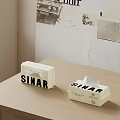 Two SINAR Tissue Boxes On Wooden Table In Interior With Poster Wall