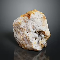 Close Up View of Natural White Yellow Mineral Stone Specimen on Black Reflective Background