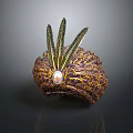Ornate Decorative Hat With Green Feathers Gold Patterns And Central Pink Gemstone
