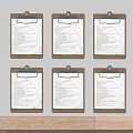 Six Brown Clipboards With Papers Hanging On Gray Wall Above Wooden Surface