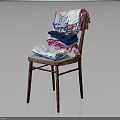 Colorful Stacked Clothes on Red Wooden Chair with T-shirts and Towels against Dark Background