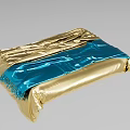 Gold And Blue Foil Wrapped Object With Wrinkles And Fringe Details