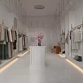Modern Bright White Clothing Store Spacious Interior Clothing Racks Central Display Table Pink Flowers Accessories