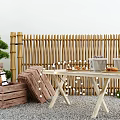 Elegant Garden Decor with Bamboo Fence Wooden Crates Table String Lights and Green Plant