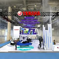 Yamaha Modern Exhibition Booth Featuring White Vehicle Blue Carpet And Purple Decorations