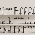 Various Styles Of Water Faucets Displayed On Multiple Tiered Shelves