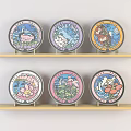 Colorful Decorative Plates With Cartoon Designs On Wooden Wall Shelves