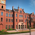 Garden Landscape with Red Brick Building Clock Tower Spire Lamp Posts and Neat Pathways