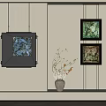 Light Colored Wall Interior With Black Framed Artworks And White Vase With Dried Branches