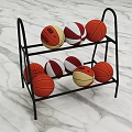 Two Tier Black Metal Sports Equipment Rack Holding Multiple Basketballs with Various Designs