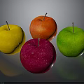 Four Colorful Apples in Yellow Red Pink and Green on Dark Background