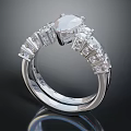 Elegant Platinum Ring With Central Diamond And Side Diamonds In Classic Design