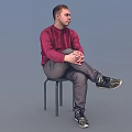 Man Sitting On Chair In Red Sweater Gray Pants Black Sneakers Against Light Blue Background